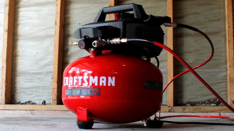 Craftsman Portable Electric 6-Gallon 150 PSI Pancake Air Compressor sitting in construction site