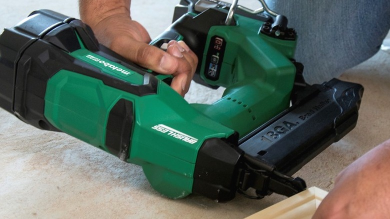 Person using Metabo HPT 2-inch 18-Gauge Cordless Straight Brad Nailer on wood frame