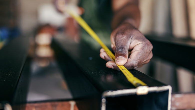 man holding measuring tape