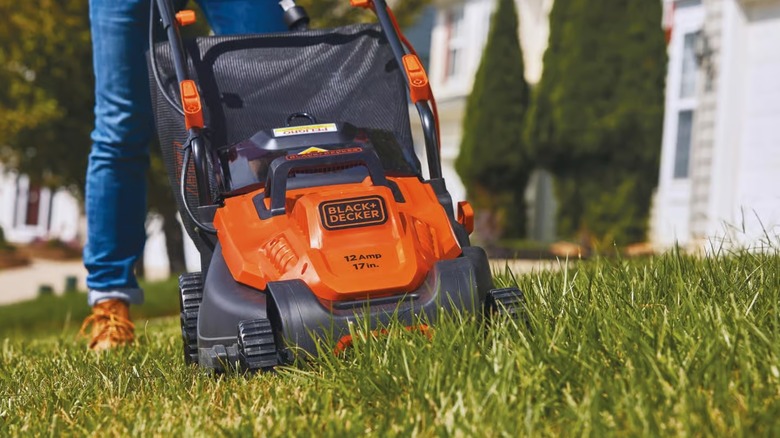 A Black+Decker lawn mower in use.
