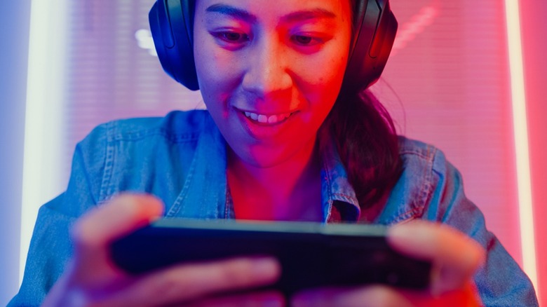 A woman playing video games on a phone