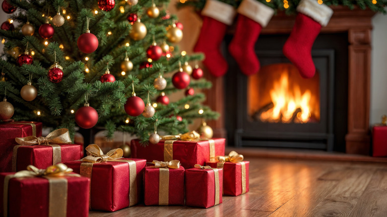 Christmas gifts under a tree and fireplace