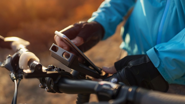 man on bike holding phone