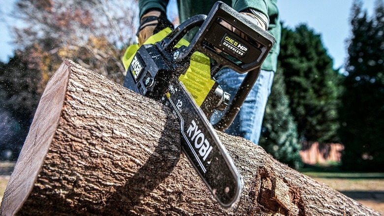 Person using chainsaw