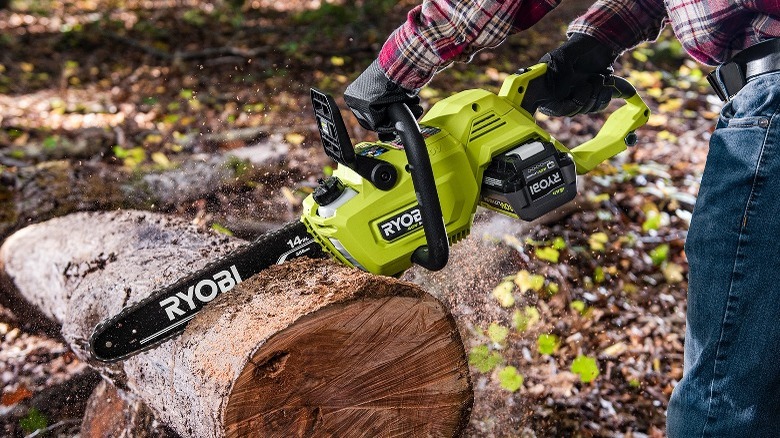 Person using chainsaw