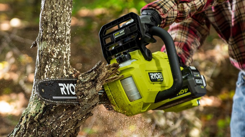 Person using chainsaw