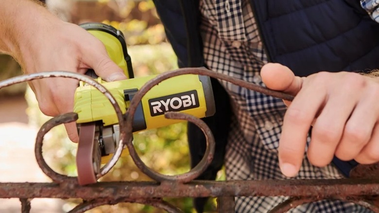 Person using Ryobi Belt Sander