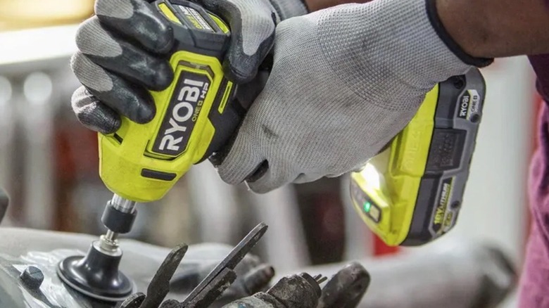 Person using Ryobi Right Angle Die Grander in a workshop