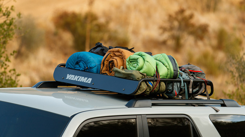 A white Toyota 4Runner with a roof basket.