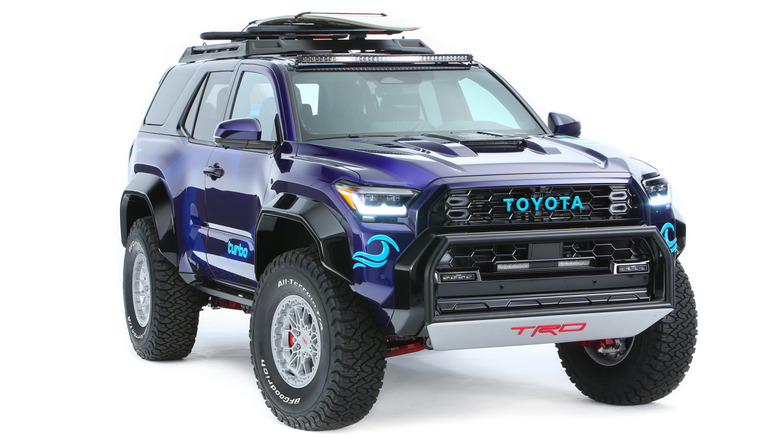 A Blue Toyota 4Runner TRD with a surf board loaded on top.