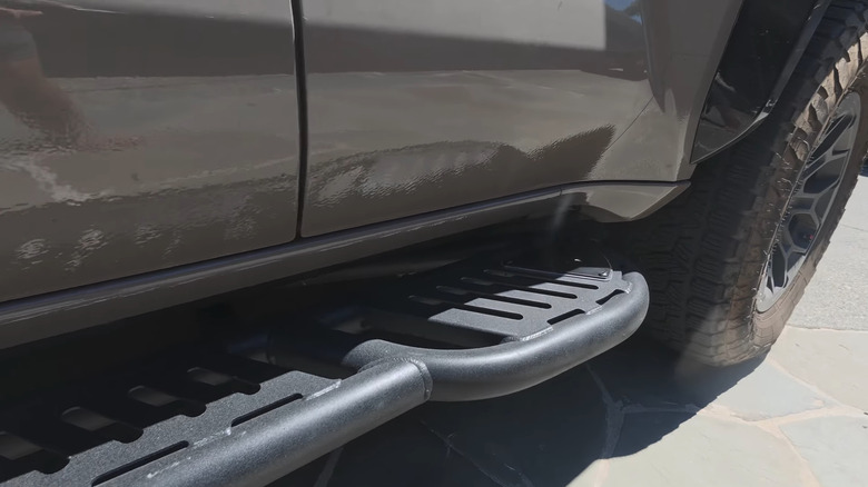 An aftermarket steel rock sliders mounted on a fifth-gen Toyota 4Runner.