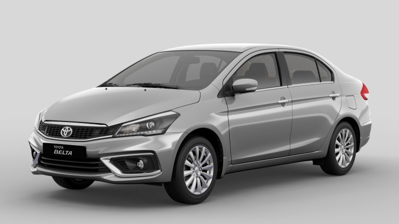 Silver Toyota Belta on a gray background