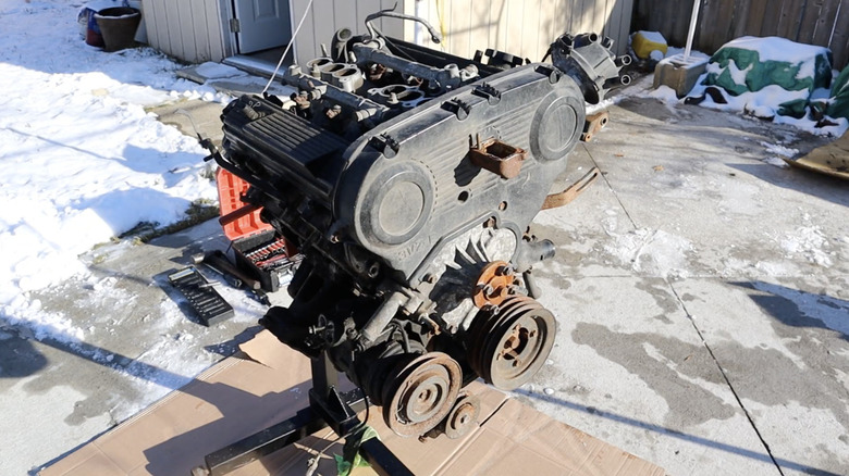 Toyota 3VZ-FE on an engine hoist in a driveway.