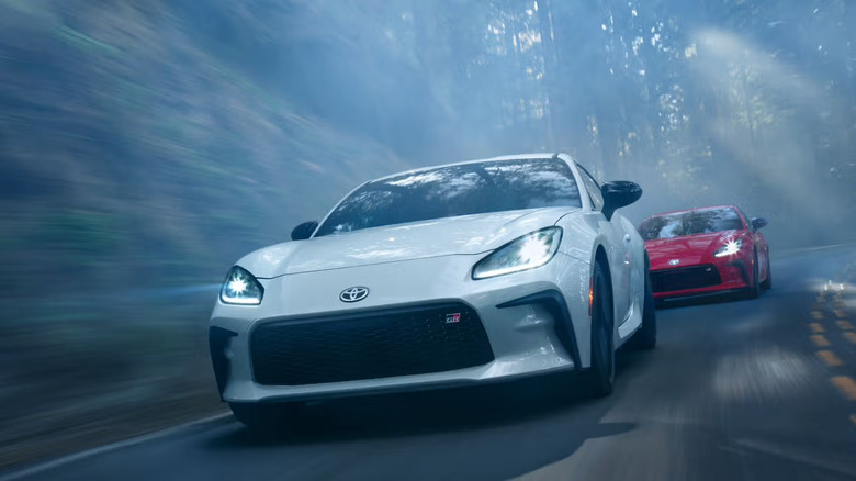 Two 2024 Toyota GR86 models driving down mountain road