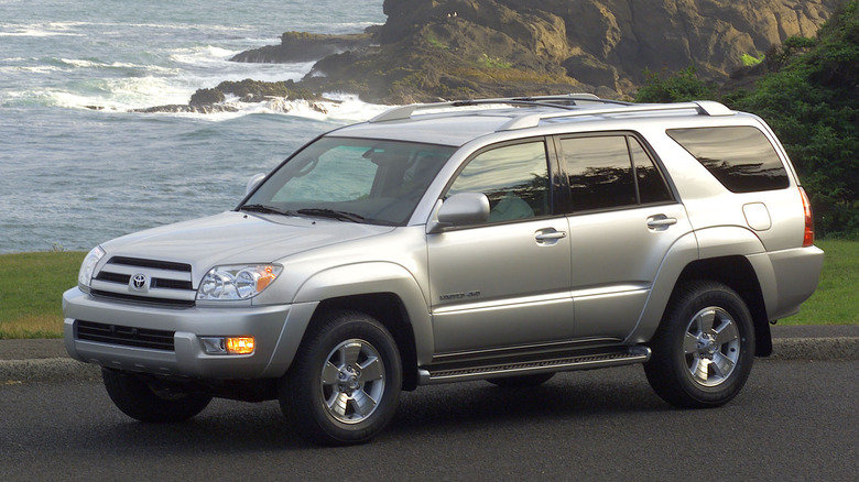 Front three-quarter view of silver fourth-generation Toyota 4Runner parked in front of ocean.