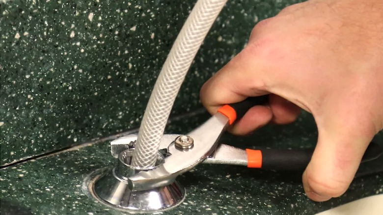Person using pliers from Tractor Supply Co.