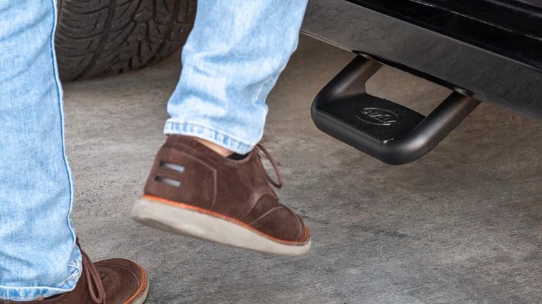 A foot steps onto a truck with a Bully Universal Truck Bed Side Step.