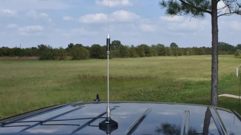 A Tram Stainless Steel Whip CB Magnet-Mount Antenna Kit mounted to the roof of a vehicle.