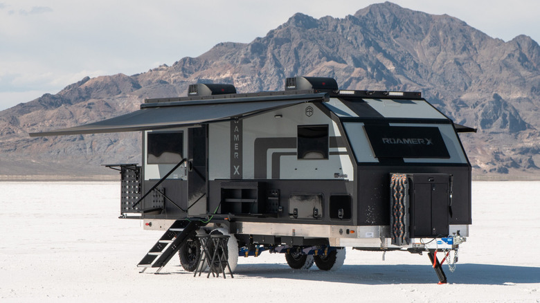 The Roamer X trailer parked in the dessert in front of mountainous terrain