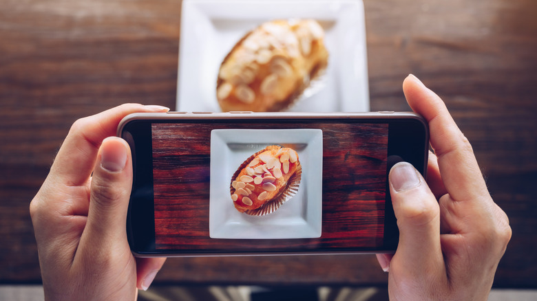 person taking picture of food