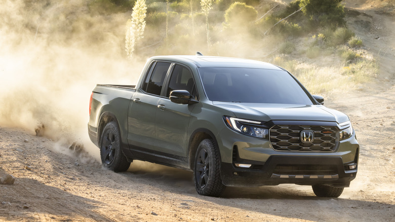 Gray 2026 Honda Ridgeline driving in sandy terrain