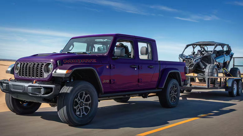 Purplse 2026 Jeep Gladiator Mojave towing recreational vehicle on a desert road
