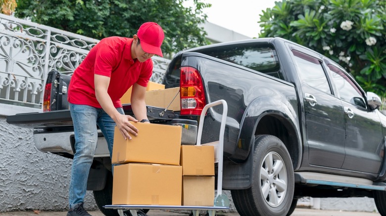 delivery man loading pickup truck