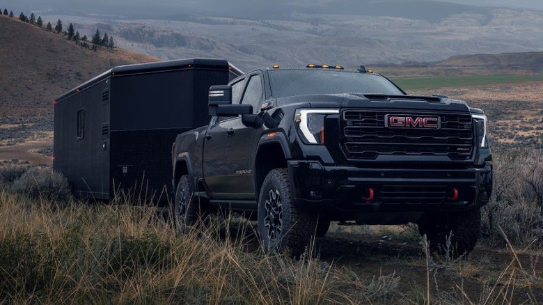 A black GMC Sierra towing a trailer