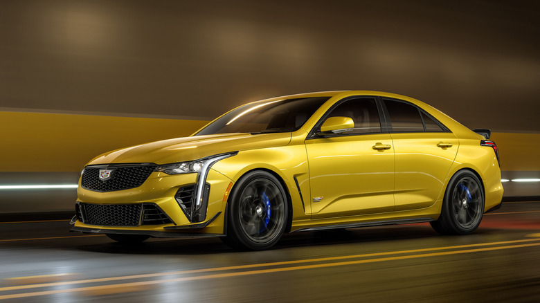 Front 3/4 view of gold Cadillac CT4-V Blackwing driving in tunnel.