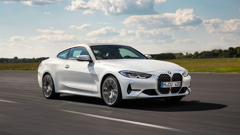 A white 2021 BMW 4 Series Coupe driving