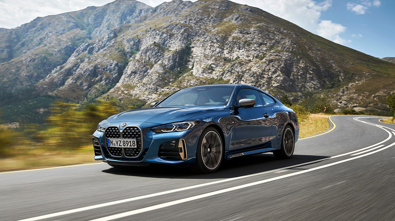 A blue 2021 BMW 4 Series Coupe driving