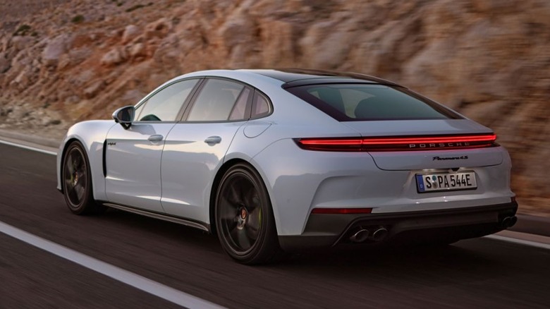 White Porsche Panamera driving down a road