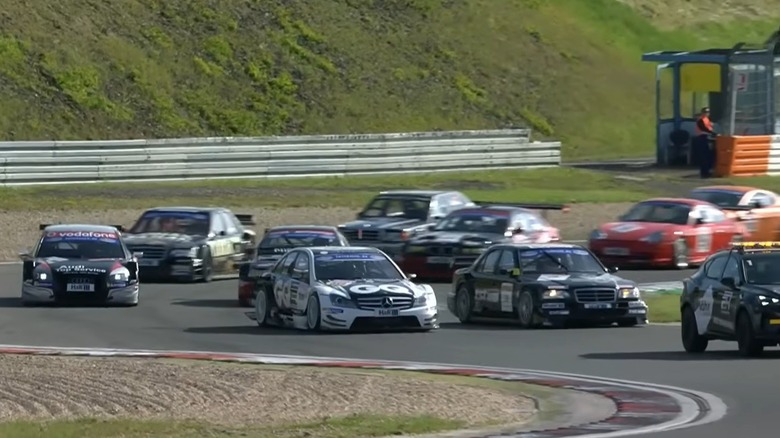 Front view of race cars cornering during Tourenwagen Legenden formation lap at Nurburgring