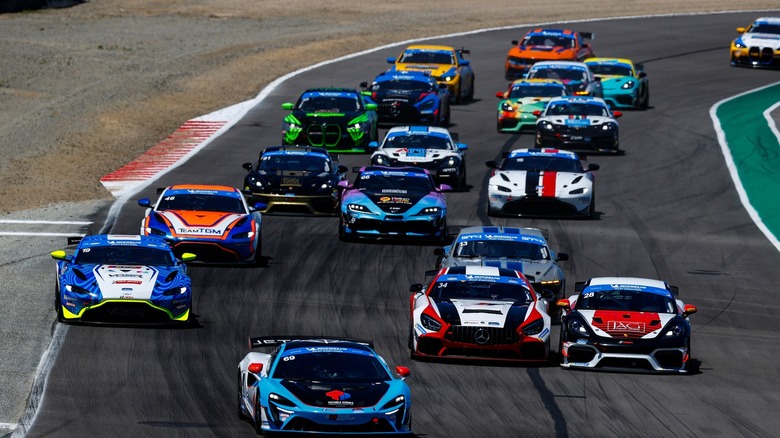Multiple race cars on the track at Laguna Seca during Michelin Pilot Challenge Laguna Seca 120 2025 race