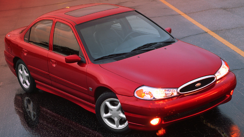 A dark red Ford Contour from 1998, being the SVT trim, parked on asphalt at an angle.