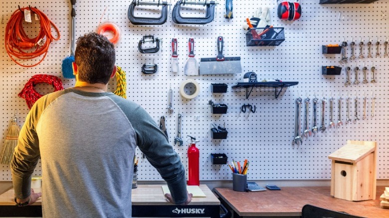 Man looking at Husky tools on peg board