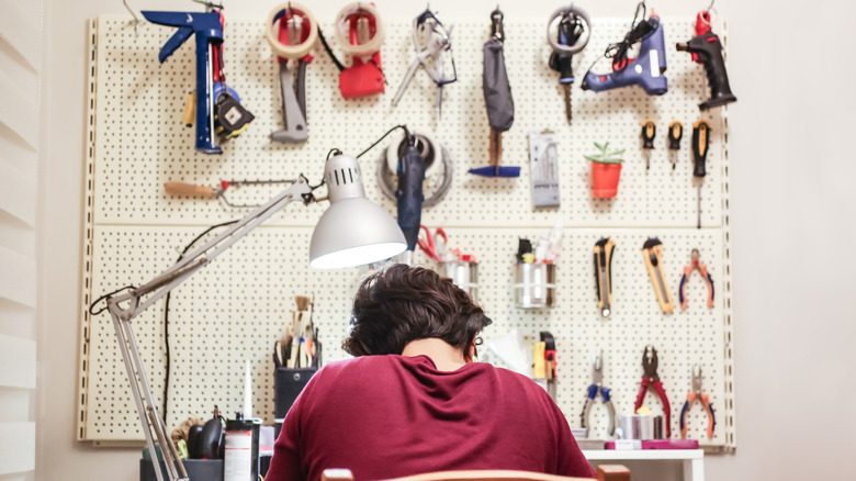 person in front of tool wall