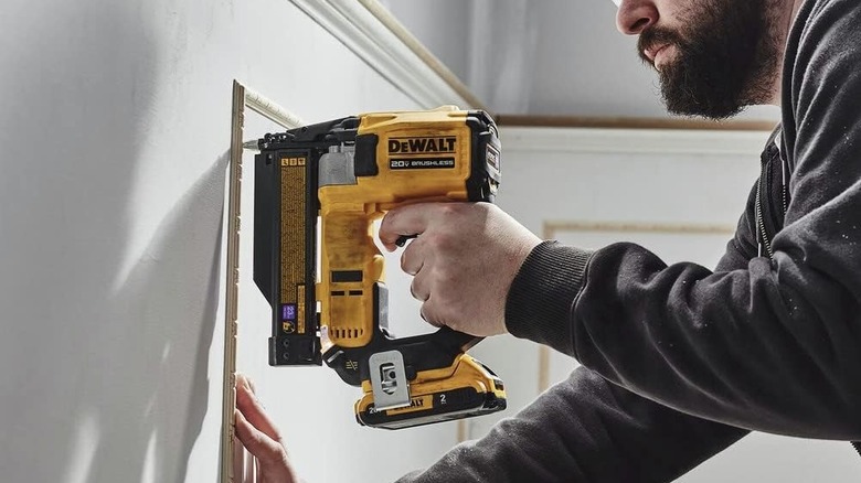 Man using DeWalt  Pin Nailer on wall
