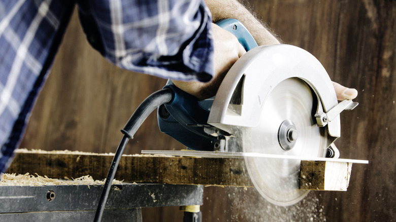 Man using circular saw in garage