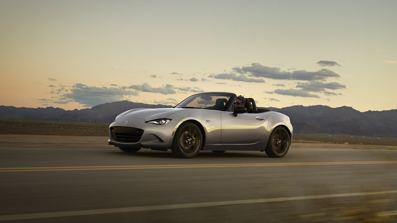 Front 3/4 view of a gray ND-generation Mazda MX-5 Miata on the move