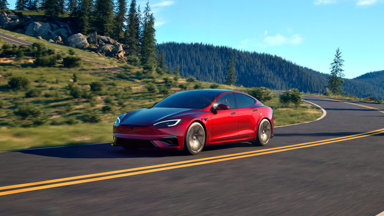 Front 3/4 of a red Tesla Model S on a mountain road