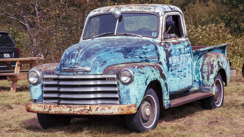 Old blue Chevrolet truck in field