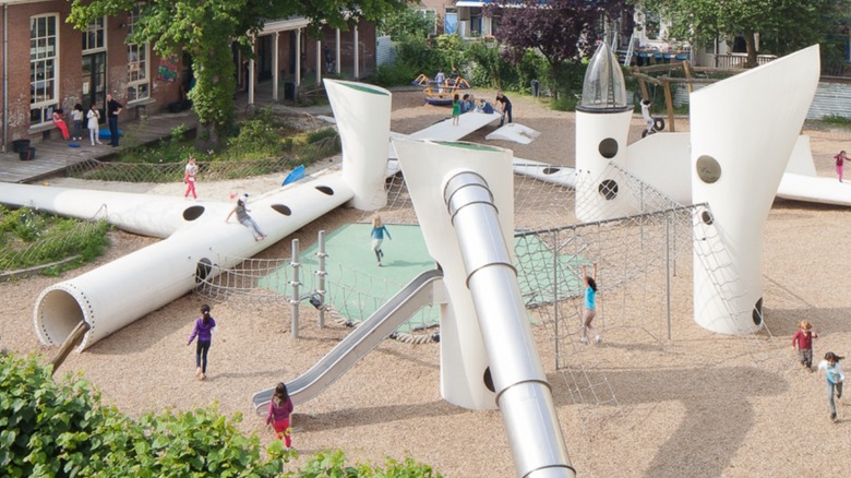 Children playing on a wind turbine blade playground.