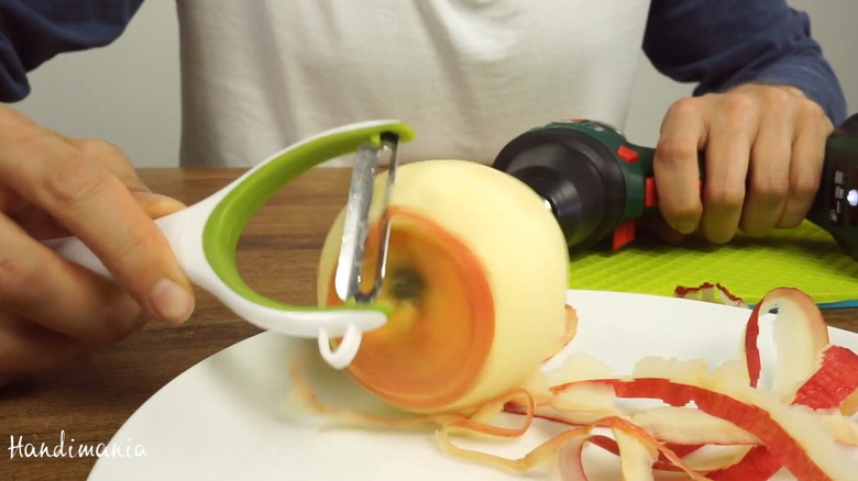 Using a cordless drill to peel an apple