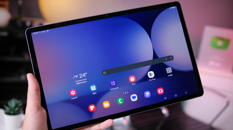 A person holds a Samsung tablet in their hand