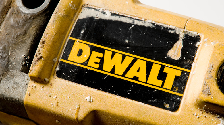 DeWalt faded logo on a dirty tool, covered in dust