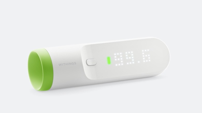 A white and green digital thermometer on a white background