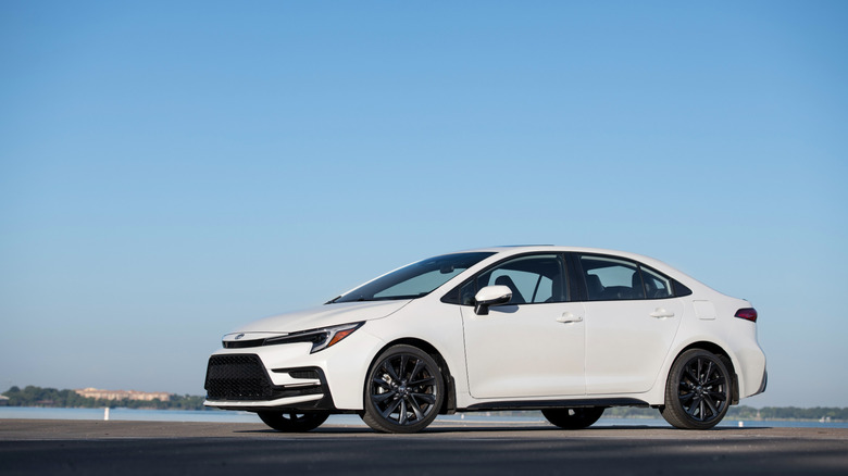 White 2026 Toyota Corolla against sky backdrop, front-left 3/4 view