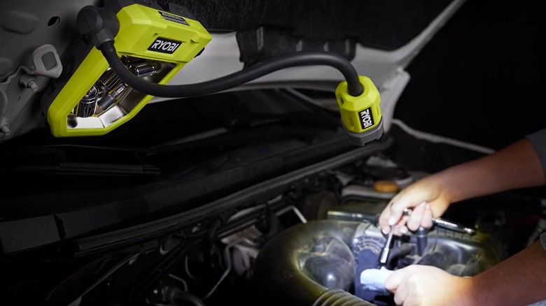 Ryobi USB Lithium LED Magnetic Tray Light Kit lighting an engine bay wfor a mechanic.