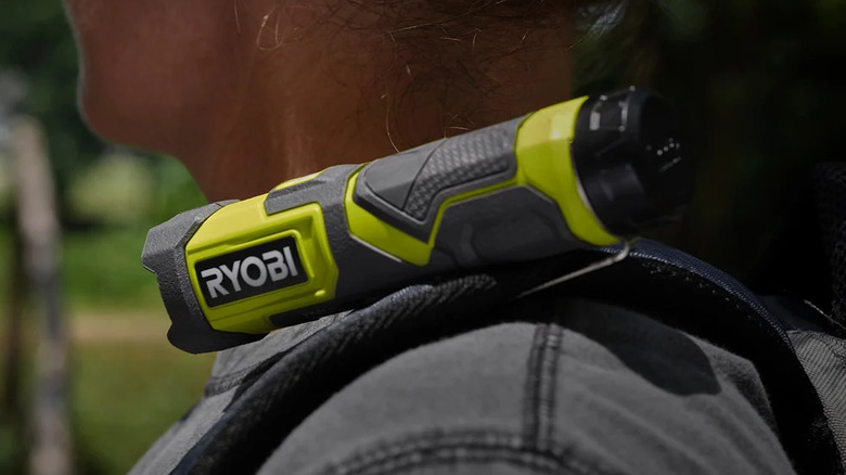 Ryobi USB Lithium compact flashlight mounted to a hiker's shoulder